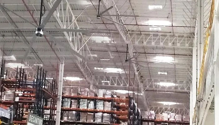 Why are industrial HVLS fans favored by warehouses?